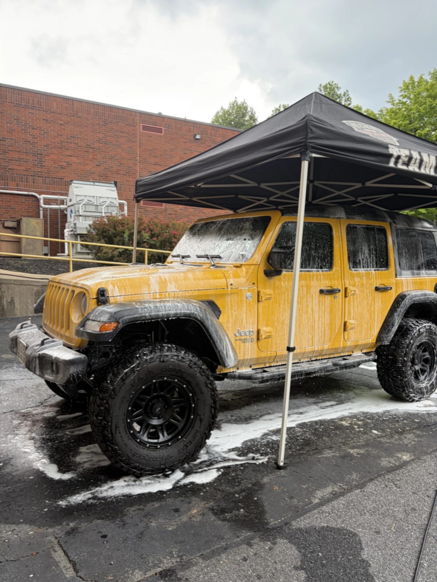 Dillpickle's Carwash detailing a Jeep under the work tent